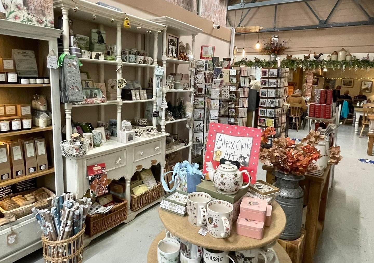 The gift shop with shelves of pottery, cards and candles
